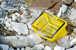 Shopping basket among rubble and rubbish