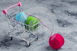 Shopping basket on wheels.The colored threads are red, green and blue