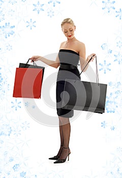Shopping blond in black dress with snowflakes