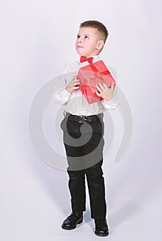 Shopping. Boxing day. New year. little boy with valentines day gift. Birthday party. tuxedo style. Happy childhood