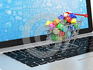 Shopping cart with applicatio icons on laptop