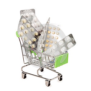 Shopping cart with blisters of tablets and pills, concept of self-treatment