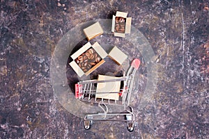 Shopping cart and cardboard boxes with coffee beans