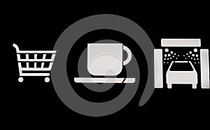 Shopping cart, coffee cup and car wash icons on black background