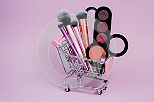 Shopping cart with cosmetics. Online sales concept