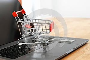 shopping cart and cradit card on laptop in office.  concept shopping online