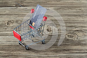 Shopping cart with credit card. Stay home shopping and electronic payment with credit card concept. Small shopping cart with credi