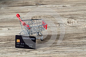 Shopping cart with credit card. Stay home shopping and electronic payment with credit card concept. Small shopping cart with credi