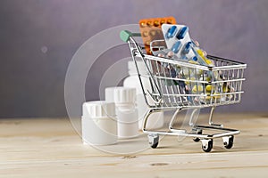 Shopping cart with different tablets and various pill bottle