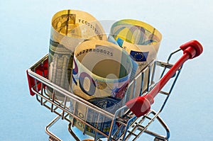 A shopping cart with euro coins