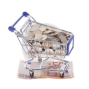 Shopping cart Euro notes and euro coins isolated on white