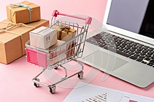 Shopping cart with purchases on pink background photo