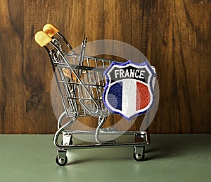 Shopping cart with French insignia.