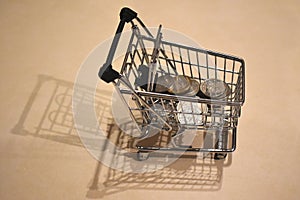 Shopping cart full of coins, concept to illustrate current crisis or deployment of an incentive program for loyal customers.