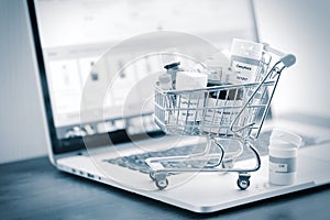 Shopping cart full of homeopathic remedies on laptop