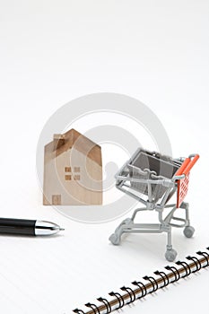 Shopping cart and house on white background. Buying new house,