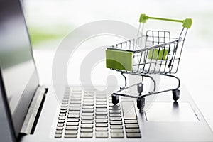 Shopping cart on laptop computer, web store or shop concept for online shopping and home delivery