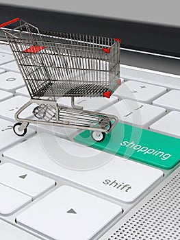 Shopping cart on laptop keyboard for e-commerce