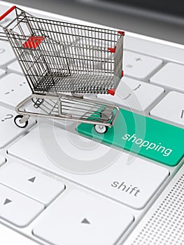 Shopping cart on laptop keyboard for e-commerce