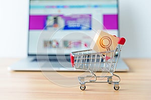 Shopping cart with Magnifying icon block and laptop computer with marketplace website, technology, ecommerce, SEO, Search Engine