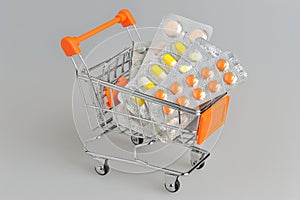 Shopping cart with medical supplies on gray