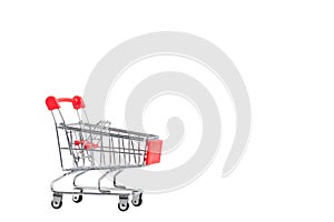 A Shopping Cart. Mini shopping trolley, isolated on white background. Mini Shopping Cart On The Table. Business , e-commerce conce