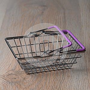 Shopping cart in a minimalist style. Shopping basket at the supermarket. Sale, discount, the concept of shopaholism. photo