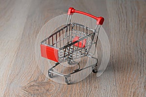 Shopping cart minimalist style. Shopping cart in the supermarket. Sale, discount, the concept of shopaholism. photo