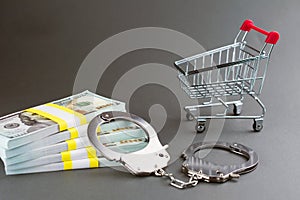 shopping cart money and handcuffs