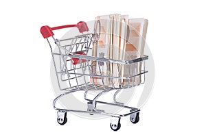 Shopping cart with money isolated on white