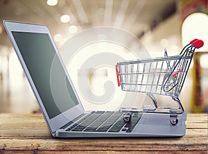 Shopping-cart over a laptop