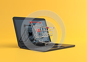 Shopping cart over a laptop computer, isolated on yellow background