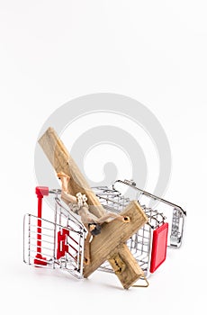 Shopping cart overturned with crucifix on the ground