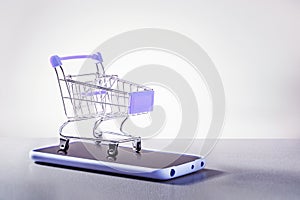 Shopping cart, phone, ecommerce and business concept, background. Online shopping concept.