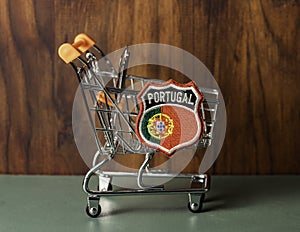 Shopping cart with Portuguese insignia.