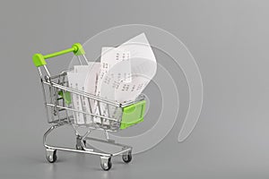 Shopping cart with receipt , concept for grocery expenses and consumerism