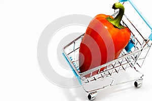 Shopping Cart with red pepper Isolated On White.Shopping concept. Copy space