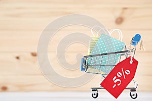 Shopping cart, red tag and paper bags