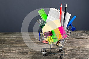 Shopping cart with school supplies. Back to school