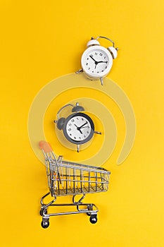 shopping cart  shopping time concept on yellow background. vertical photo