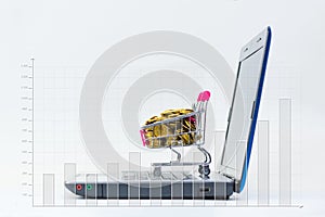 Shopping cart or supermarket trolley with laptop notebook on white background, e-commerce and online shopping concept