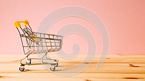 Shopping cart on wooden table