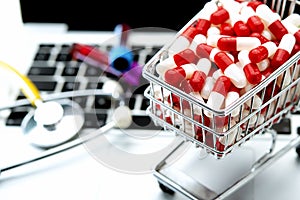 shopping cart with white and red capsules in the foreground