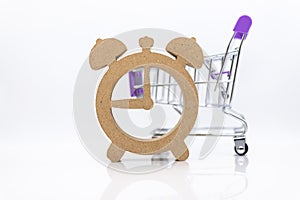 Shopping cart and wooden watch ,image use for discount period for shopping ,special price, sold out, business marketing concept