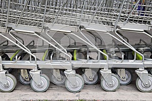 Shopping carts in a row are waiting for using.