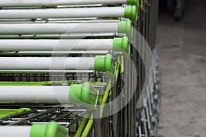 Shopping carts in a row are waiting for using.