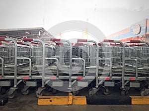 Shopping carts shopping carts in a row  to buy food and other goods in front of a mall or a big shopping center