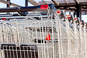 Shopping carts in the store, assembled in a row in the parking lot. Close-up. photo