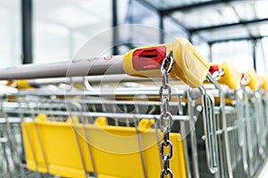 Shopping carts of a supermarket in a row, closeup