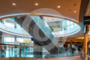 Shopping center building blurred background. People shopping in modern commercial mall center. Interior of retail centre